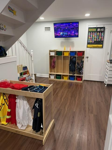 Dress-up station with costumes and wooden cubbies