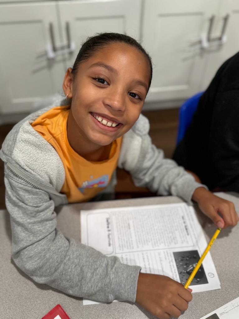 Child working on a reading and writing worksheet